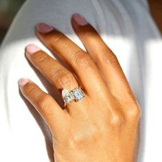 a woman's hand with a diamond ring on it