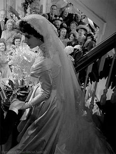 the bride and groom are walking down the stairs