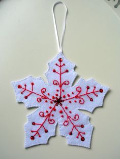 a snowflake ornament hanging on a table