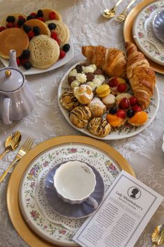 an assortment of pastries and croissants are on the table for breakfast