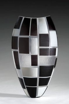 a black and white vase sitting on top of a table