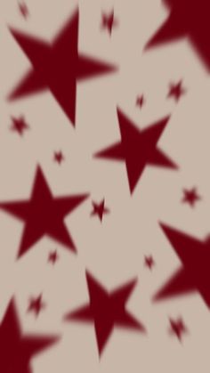 many red stars are flying in the air with their shadows on it's surface