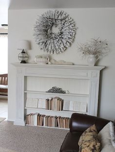 a living room filled with furniture and a fire place covered in wreaths on the wall