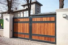 a large wooden gate in front of a house