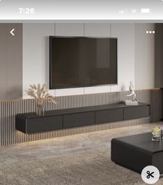 a flat screen tv mounted to the side of a wall in an empty living room