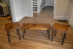 three wooden benches sitting on top of a hard wood floor