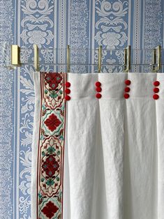 towels hanging on a towel rack in front of blue wallpaper