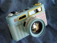 a camera sitting on top of a blue blanket