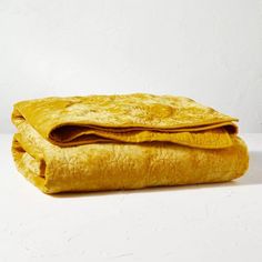 a yellow blanket folded on top of each other