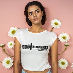 a woman standing in front of white flowers wearing a t - shirt with the words vicious on it