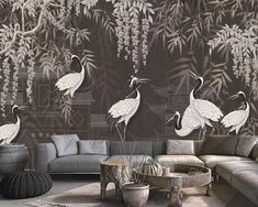 a living room filled with furniture and wallpaper covered in white cranes on the wall