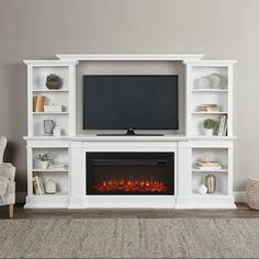 a white entertainment center with a fireplace in the middle and bookshelves on either side