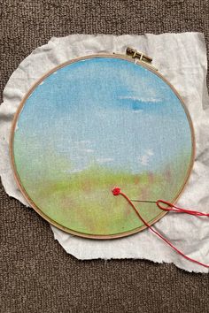 an embroidery project is being worked on with scissors