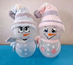 two frosty snowmen wearing hats and scarves