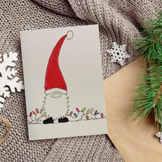 a christmas card with an image of a gnome on it