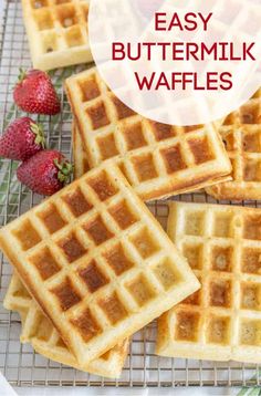 homemade buttermilk waffles on a cooling rack with strawberries