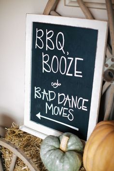 a sign that says bbq rooze and bad dance moves next to some pumpkins