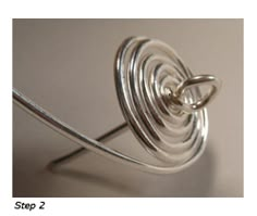 a close up of a metal object on a white surface with the words step 2