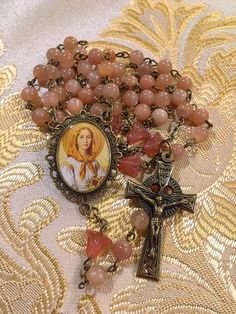 a rosary with an image of a woman on it