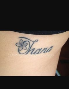 a woman with a name tattoo on her lower arm and the word thanu written in cursive font