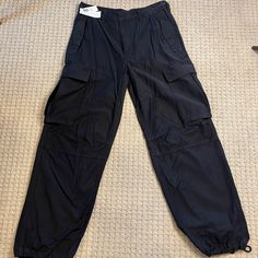 Nwt Tna Supply Cargo Pant From Aritzia Size 10. Color: Black Never Worn - Excellent Condition. Features Zip Fly Closure Side And Back Pockets Cargo Side Pockets Measurements: Waist 16" Rise 11" Inseam 30" Material: 100% Cotton Bundle And Save! 10% Discount On Bundles Of 2 Or More! Reasonable Offers Accepted Aritzia Tna Jumpsuit, Black Cargos, Black Cargo, Cargo Pant, Pant Jumpsuit, Straight Leg, Pants For Women, Bundles, Size 10