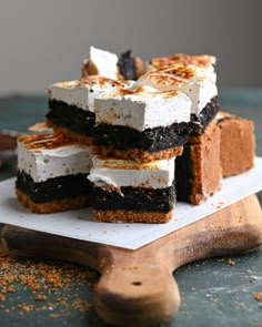 several pieces of cake sitting on top of a cutting board