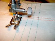 the sewing machine is working on the piece of fabric that has been stitched together