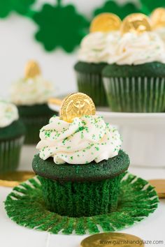 cupcakes with white frosting and green sprinkles