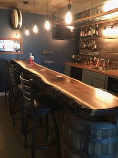 a wooden bar with stools in a room