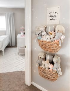 there are many stuffed animals in the basket on the wall next to the door way