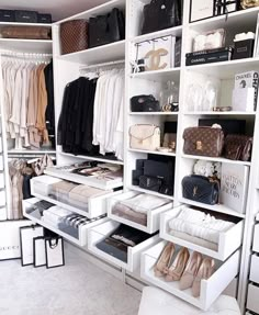 an organized closet with white shelving and lots of shoes, handbags and purses