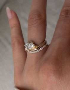 a woman's hand with a ring on it and a diamond in the middle