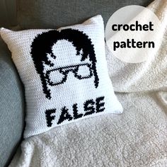 a crocheted pillow with the words false on it and a photo of a man wearing glasses