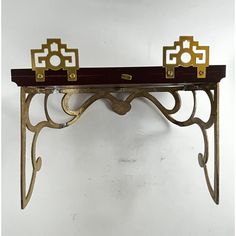 a metal shelf with two gold handles on it