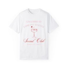 This Gingerbread Espresso Martini Social Club Christmas T-shirt exudes a cozy and festive vibe, perfect for holiday gatherings and celebrations. The relaxed fit and classic crew neckline make it a versatile piece for both casual and semi-formal settings. Ideal for those who love Christmas parties and unique holiday shirts. Product features - Available in sizes S to 4XL for the perfect fit - Double-needle stitching for durability - Garment-dyed fabric for a soft color and texture - Made with high-quality 100% US cotton - Available in 58 colors for a wide variety of options Care instructions - Machine wash: cold (max 30C or 90F) - Do not bleach - Tumble dry: low heat - Iron, steam or dry: low heat - Do not dryclean White Graphic Print Shirt For Holiday, Holiday Party T-shirt With Short Sleeves, White Graphic Print Top For Holiday, White Christmas Graphic Tee Tops, Holiday White T-shirt With Graphic Print, White Christmas Graphic Tee, White Graphic Tee For Holidays, Holiday White Graphic Tee Top, White Graphic Tee For Holiday