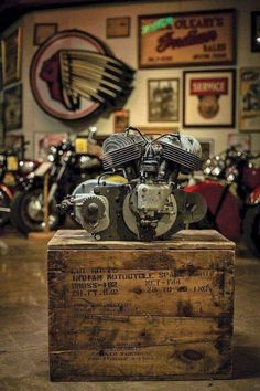 a motorcycle engine sitting on top of a wooden box