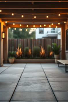 an outdoor patio with lights and benches