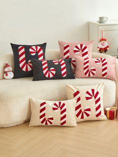 a white couch with candy cane pillows on it