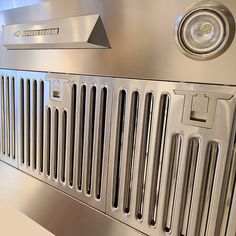 a stainless steel ventilator on the side of a wall in an office building