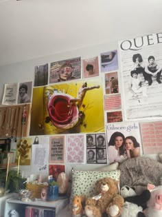 a room with many pictures and stuffed animals on the wall