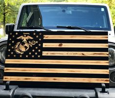 an american flag painted on the back of a truck with marine emblems and stars