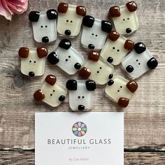 bear shaped glass cabochons with brown, white and black spots on them next to a card