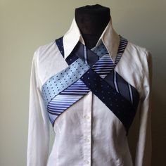 a white shirt with blue and black stripes on the collar is being worn by a mannequin