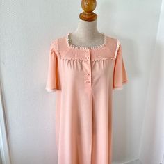 VINTAGE PINK LACE NIGHTGOWN 1970 1970s long nightgown. The dress is in orange-pink cotton and polyester. Edged with lace on the neckline, sleeves and bottom of the dress. Buttons on the front. Short sleeves. French made. From the Lingelor brand. Very good state. DIMENSIONS: The nightgown fits a size S - M The flat measurements are: Shoulder width: 40 centimeters Chest width: 55 centimeters Length: 111 centimeters Sleeve length: 28 centimeters Fast, tracked and careful shipping. Feel free to cont Retro Dresses With Lace Trim For Loungewear, Vintage Pink Dress For Night Occasion, Vintage Pink Dress For Night, Retro Loungewear Dresses With Lace Trim, Retro Summer Nightgown For Sleep, Retro Nightgown For Sleepovers, Retro Sleep Dress With Lace Trim, Retro Pink Sleepwear For Spring, Retro Sleepwear With Lace Trim For Bedtime