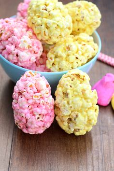 two bowls filled with popcorn balls on top of a wooden table