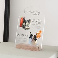 an acrylic sign with a cat and oranges on it that says signature distillation