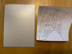 a piece of paper with a drawing of a zebra on it next to a cutout