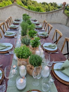 a table set with place settings and candles