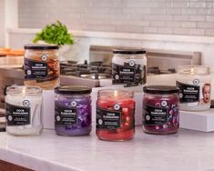 candles are lined up on a kitchen counter