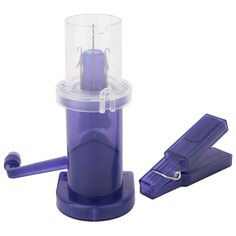 a purple plastic object with a clear lid and two pieces of blue material in front of it